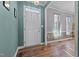 Bright foyer featuring hardwood floors, neutral paint, and transom window, creating an inviting entry at 3809 Long Meadow Dr, Mebane, NC 27302