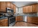 Functional kitchen featuring oak cabinets, modern appliances, and durable countertops for cooking at 3809 Long Meadow Dr, Mebane, NC 27302