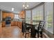 Open kitchen with oak cabinets, adjacent dining area, and large windows providing a bright and airy space at 3809 Long Meadow Dr, Mebane, NC 27302