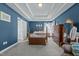 This bedroom features a tray ceiling, carpet floors, and natural light at 3809 Long Meadow Dr, Mebane, NC 27302