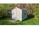 Backyard shed with double doors and a small window for storage at 3809 Long Meadow Dr, Mebane, NC 27302