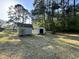 Backyard showcasing two storage sheds for all your outdoor storage needs and a backdrop of mature trees at 3815 Weyburn Rd, Durham, NC 27704