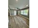 Bright living room with new floors, fresh paint, and a large window for natural light at 3815 Weyburn Rd, Durham, NC 27704