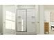 Bright bathroom featuring glass enclosed shower, decorative shelves, and stylish decor at 385 Thompson Overlook Way # 236, Smithfield, NC 27577
