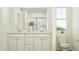 Bright bathroom with double vanity, stylish decor, and a large window at 385 Thompson Overlook Way # 236, Smithfield, NC 27577