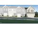 New townhome with stylish vertical siding, stone accents, attached garage, and tasteful landscaping at 385 Thompson Overlook Way # 236, Smithfield, NC 27577