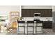 Modern kitchen with dark cabinets, white subway tile backsplash, and bar seating at the island at 385 Thompson Overlook Way # 236, Smithfield, NC 27577