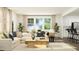Bright, open-concept living space with a white sofa, complemented by a dining area and stylish decor at 385 Thompson Overlook Way # 236, Smithfield, NC 27577