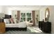 Serene main bedroom featuring a luxurious bed, stylish decor, and natural light at 385 Thompson Overlook Way # 236, Smithfield, NC 27577
