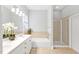 Bathroom with double vanity, bathtub, walk in shower, and tile flooring at 4 Calwell Creek Dr, Chapel Hill, NC 27517