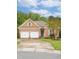 Charming brick home with a two-car garage, well-maintained lawn and colorful landscaping at 4 Calwell Creek Dr, Chapel Hill, NC 27517