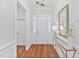 Bright foyer featuring hardwood floors, a decorative mirror, and a chandelier at 4 Calwell Creek Dr, Chapel Hill, NC 27517