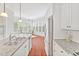 Bright kitchen with stainless appliances connects to window-lined breakfast nook at 4 Calwell Creek Dr, Chapel Hill, NC 27517