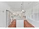 Open concept kitchen with stainless steel appliances, granite counters, and hardwood floors at 4 Calwell Creek Dr, Chapel Hill, NC 27517