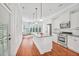 Bright kitchen boasts white cabinets, granite counters, stainless steel appliances, and hardwood floors at 4 Calwell Creek Dr, Chapel Hill, NC 27517