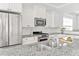 Close up of a kitchen with stainless steel appliances, granite countertops, and white cabinets at 4 Calwell Creek Dr, Chapel Hill, NC 27517