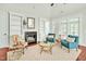 Inviting living room featuring fireplace, built-in shelves, hardwood floors, and comfortable seating at 4 Calwell Creek Dr, Chapel Hill, NC 27517