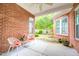 Covered patio with brick columns and view of the landscaped yard at 4 Calwell Creek Dr, Chapel Hill, NC 27517