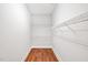 Walk-in closet with hardwood floor and white wire shelving is ready for storage at 4 Calwell Creek Dr, Chapel Hill, NC 27517