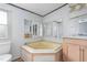 Cozy bathroom with a unique corner tub and ample vanity storage at 4047 Mistletoe Dr, Burlington, NC 27217
