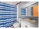 Bathroom with blue striped shower curtain, and cream colored counter at 4047 Mistletoe Dr, Burlington, NC 27217