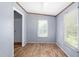 Bright bedroom with neutral walls, wood-look floors, and natural light from a window at 4047 Mistletoe Dr, Burlington, NC 27217