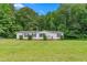 Charming single-story home with a well-manicured lawn and mature trees at 4047 Mistletoe Dr, Burlington, NC 27217