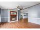 Living room featuring a classic fireplace and wood-look floors that flow into the kitchen at 4047 Mistletoe Dr, Burlington, NC 27217