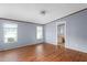 Bright living room with wood-look flooring and natural light from two windows at 4047 Mistletoe Dr, Burlington, NC 27217