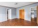 Spacious living room featuring wood-look flooring and multiple doorways at 4047 Mistletoe Dr, Burlington, NC 27217