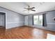 Comfortable living area with wood-look floors, large windows, and a traditional fireplace at 4047 Mistletoe Dr, Burlington, NC 27217