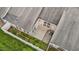 Aerial view of a backyard featuring a concrete patio, brick pathway, and well-maintained lawn enclosed by a white fence at 4105 Gilchrist Dr, Burlington, NC 27215