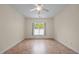 Bedroom features neutral walls and flooring, ceiling fan, and a window with blinds and curtains at 4105 Gilchrist Dr, Burlington, NC 27215