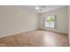Bedroom features neutral walls and flooring, ceiling fan, and window with blind and curtains at 4105 Gilchrist Dr, Burlington, NC 27215