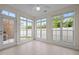 Bright sunroom enclosed with numerous windows offering an abundance of natural light at 4105 Gilchrist Dr, Burlington, NC 27215