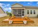 Charming backyard deck featuring wooden chairs and a screened-in porch for relaxation and outdoor enjoyment at 412 Airedale Trl, Garner, NC 27529