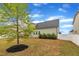 Spacious backyard with healthy green tree and partial fence provides an open canvas for landscaping at 412 Airedale Trl, Garner, NC 27529