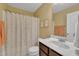 Bright bathroom featuring a floral shower curtain, marble countertops, and natural lighting at 412 Airedale Trl, Garner, NC 27529