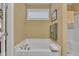 Bright bathroom with a soaking tub and window providing natural light at 412 Airedale Trl, Garner, NC 27529