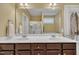 Bright bathroom with double sink vanity and a walk in shower with glass doors at 412 Airedale Trl, Garner, NC 27529