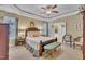 Comfortable bedroom with decorative tray ceiling, ceiling fan, and plush furnishings at 412 Airedale Trl, Garner, NC 27529