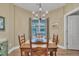 Cozy dining room featuring a wooden table, chandelier lighting and natural sunlight from the window at 412 Airedale Trl, Garner, NC 27529