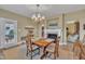 Inviting dining room featuring a chandelier and a view of the fireplace and back patio at 412 Airedale Trl, Garner, NC 27529