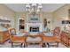 Formal dining room features a fireplace, elegant chandelier, and adjacent kitchen at 412 Airedale Trl, Garner, NC 27529