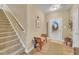 Inviting entryway with staircase, bench seating, decorative wreath, and wood-look flooring at 412 Airedale Trl, Garner, NC 27529