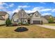 Well-maintained home with manicured lawn, lush landscaping, and a two-car garage, offering curb appeal at 412 Airedale Trl, Garner, NC 27529