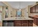 Kitchen island with granite countertops, stainless dishwasher and overhead pendant lighting at 412 Airedale Trl, Garner, NC 27529