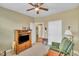 Neutral living room featuring a television, closet, and green arm chair at 412 Airedale Trl, Garner, NC 27529