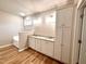 Bright bathroom featuring double vanity with granite counters, cabinets, and bathtub at 437 Earnest Way, Kenly, NC 27542