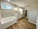 Bathroom including a soaking tub, and vanity with granite counters at 437 Earnest Way, Kenly, NC 27542
